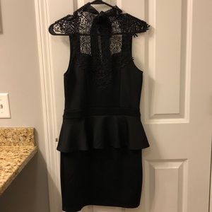 Black peplum dress with lace detailing chest